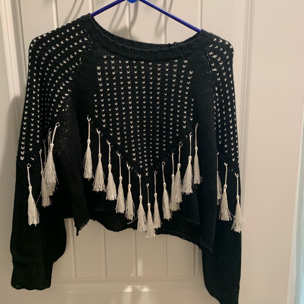 Cropped, tasseled sweater.